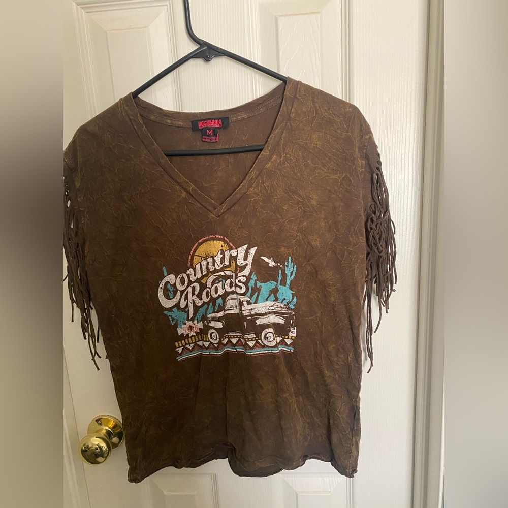 Women’s country shirt with fringe sleeves.